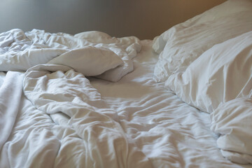 The white crumpled mattress in the bedroom.