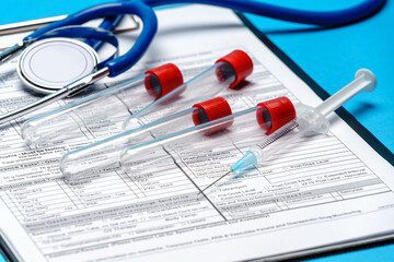 Clipboard with paper blank form with medical tools on blue background with cope space