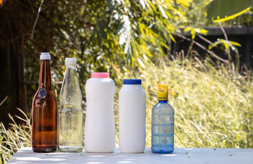 Different types of bottles. Natural background.