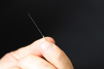 close up of an acupuncture needle being held