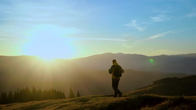 A man travels in the mountains. Beautiful nature of the Carpathian mountains. The concept of travel and active lifestyle. 4K