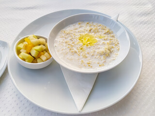 Oatmeal with fresh berries and fruits in a bowl on top. Healthy lifestyle, healthy eating, diet, fitness and vegetarian food concept
