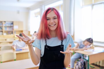 Teenage student taking exam, classroom with study students background
