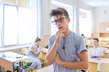 Smart teenager student male taking exam, answers lesson