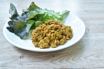 spicy stir fried chop pork with yellow turmeric curry eat couple red oak Thai southern food on dish