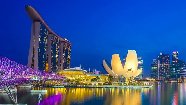 Timelapse of Cityscape view with sunset and twilight time main light color showplaces, view marina bay and helix bridge landmark