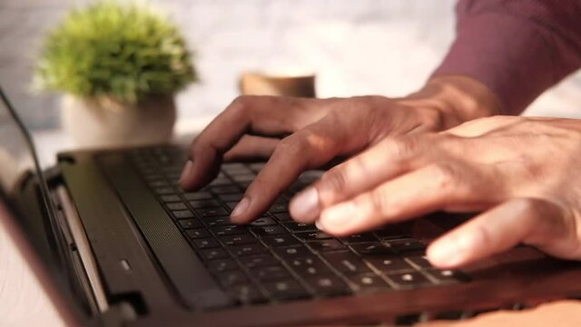 Close up of man hand typing on keyboard 
