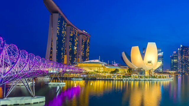 Timelapse of Cityscape view with sunset and twilight time main light color showplaces, view marina bay and helix bridge landmark