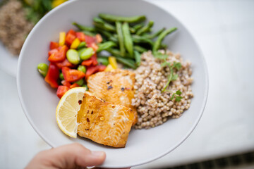 Salmon and buckwheat dish with green beans and tomato
