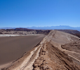 Lonely trail on dune in valley of the moon, Atacama salt desert, Chile