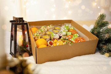 Christmas, New Year, food delivery in boxes. Salads, caviar, bruschettas at home in quarantine