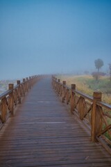wooden bridge in the morning fog.
