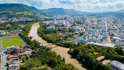 Fototapeta na wymiar Rio do Sul - SC. Aerial view of the city and Itajaí river with its bridges