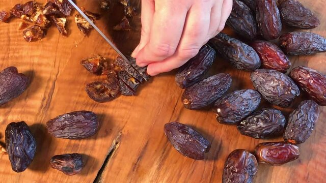 chopping dried Medjool dates on cutting board flat lay