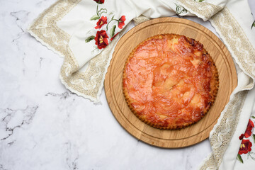 baked round apple pie on wooden board