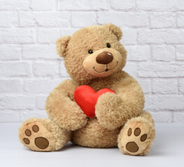 brown teddy bear sits on a white background, children's toy