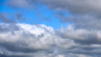 Dark clouds against a blue sky