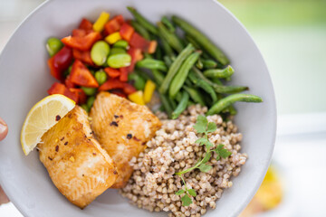 Salmon and buckwheat dish with green beans and tomato