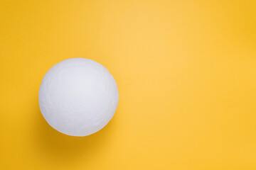 night lamp in the shape of a moon on a yellow background top view. space for copying text