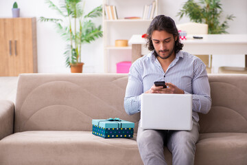 Young man in christmas concept at home