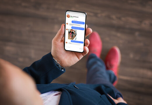 Man exchanging lovely messages with his girlfriend on phone