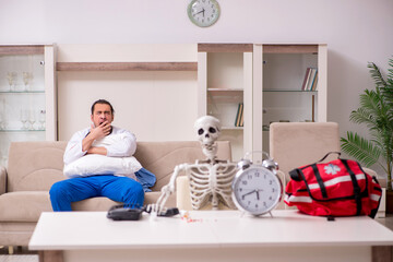 Young male paramedic visiting skeleton patient