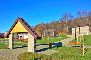 Fototapeta na wymiar New resting park in Wapienne Spa with graduation tower, plus swings and slides, so that you can quickly overcome the space between the terraces of the playground