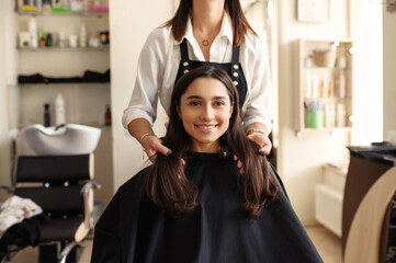Hairdresser and customer in hairdressing salon