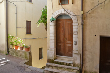 Fototapeta na wymiar A narrow street with among the old houses of Rivello, a medieval village in the Basilicata region.