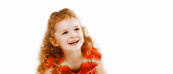 Portrait of happy smiling little girl child looking up over a white background