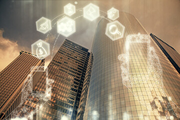 Double exposure of technology theme hologram and cityscape background. Concept of Hightech.