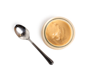 Milk pudding dessert in jar with spoon. Isolated with clipping p