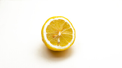 Fototapeta na wymiar Front view of a half cut fresh yellow lemon on a isolated white background.