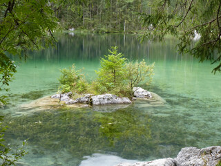 Naklejka na ściany i meble Crystal clear water in a mountain lake in the bavarian alps