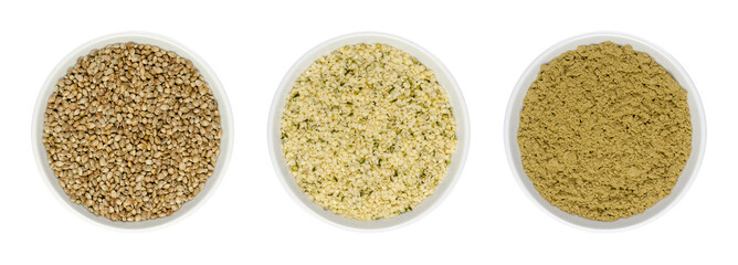 Hemp seeds in white bowls, isolated on white background. Whole, hulled and ground hempseeds. Cannabis sativa fruits. Healthy protein source and meat alternative. Close-up from above, macro food photo.