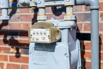 Gas Meter with pipes on a brick wall