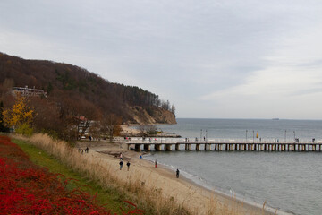 Fototapeta na wymiar pier on the beach pier in the gray autumn day 
