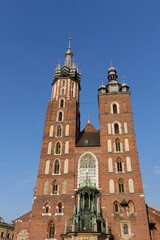 Fototapeta na wymiar KRAKOW, POLAND -View of the Saint Mary's Basilica, a brick Gothic church on the Main Market Square in Kraków, Poland.