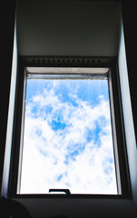 Image of attic window with blue sky view.