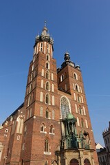 Naklejka na ściany i meble KRAKOW, POLAND -View of the Saint Mary's Basilica, a brick Gothic church on the Main Market Square in Kraków, Poland.