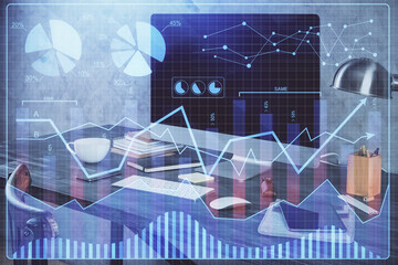 Financial graph colorful drawing and table with computer on background. Double exposure. Concept of international markets.
