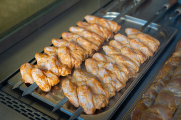 chicken wings prepared for grilling on tray