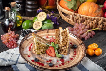 Fototapeta na wymiar carrot cake on a plate on a wooden table with fruits rustic style