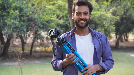 Young blogger with tripod -Indian Blogger images