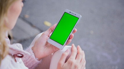 Women holding a phone in the park