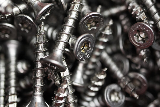 Viersen, Germany - May 9. 2020: Macro close up of isolated pile metal self-drilling Spax screws in tool box