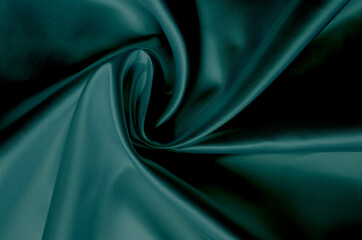 Obraz premium Green silk fabric texture close up as background. Trending color of 2021