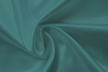 Green silk fabric texture close up as background. Trending color of 2021