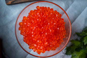 Chum salmon caviar in a glass bowl . Seafood, delicacies, healthy nutrition. 
