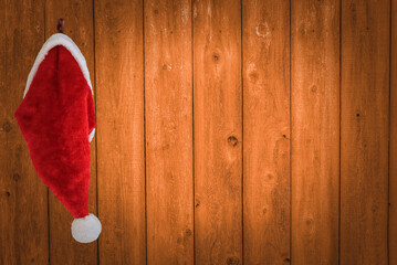 Santa's hat hanging on his workshop wall with copy space
